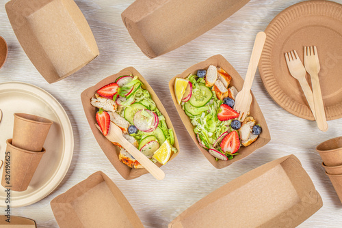 salad with chicken and vegetables served in recyclable containers. Eco friendly disposable dishes photo