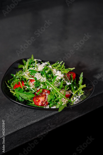 Fresh arugula and tomato salad with shaved parmesan