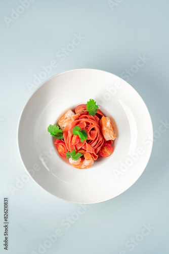 Classic homemade pasta with colored tagliatelli, cherry tomatoes photo