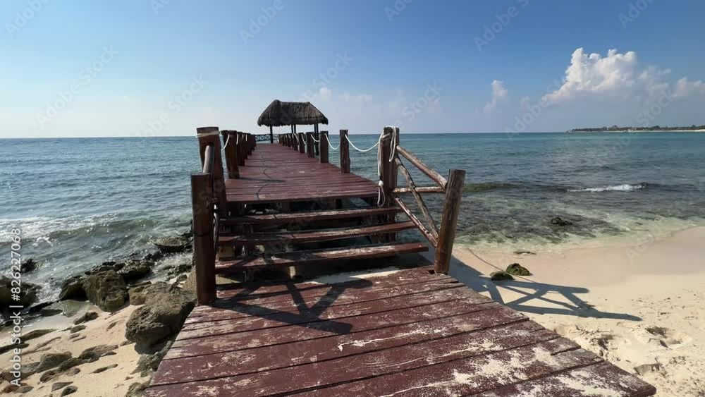 A beautiful beach dock with palapa, on the beautiful caribbean sea in the Riviera Maya, this type of pier is typical of large resorts such as Grand Oasis, Bahia Principe... A beautiful beach dock with palapa, on the beautiful caribbean sea in the Riviera Maya, this type of pier is typical of large resorts such as Grand Oasis, Bahia Principe...
