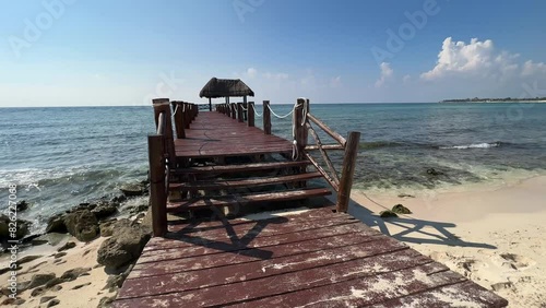 A beautiful beach dock with palapa, on the beautiful caribbean sea in the Riviera Maya, this type of pier is typical of large resorts such as Grand Oasis, Bahia Principe...