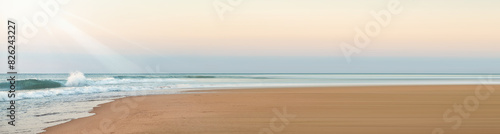 A sunrise over a waves sea. Abstract banner of pastel summer beach.