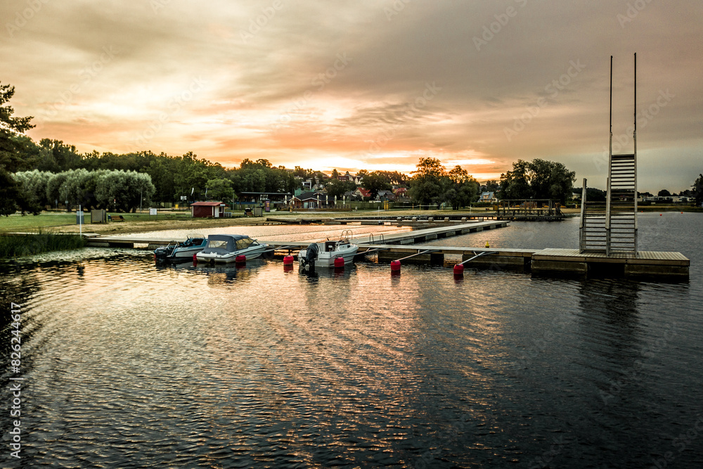 Naklejka premium sunset over the lake in Estonia, boats in harbour