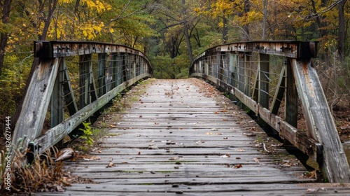 Old ruined wooden hanging bridge in over river. Scary place to walk through since the whole thing its broken © Nataliya