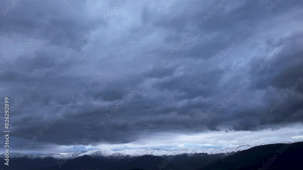 flight in Gredos in the Tietar valley with a drone visualizing the mountains with their snow-capped peaks and above them a large amount of storm clouds running in a hyperlapse in Avila Spain flight in Gredos in the Tietar valley with a drone visualizing the mountains with their snow-capped peaks and above them a large amount of storm clouds running in a hyperlapse in Avila Spain