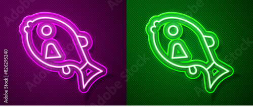 Glowing neon line Tropical fish icon isolated on purple and green background. Exotic fish. Vector