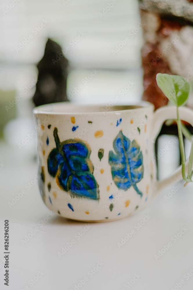 Beautiful hand-made ceramic mug displayed on the table Beautiful hand-made ceramic mug displayed on the table