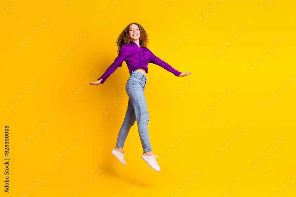 Full length photo of lovely young lady jump running dressed stylish violet garment isolated on yellow color background