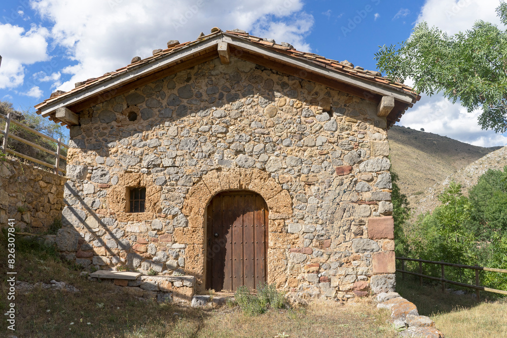 A quaint stone structure featuring a wooden door and a window, hermitage of Soledad. A quaint stone structure featuring a wooden door and a window, hermitage of Soledad.