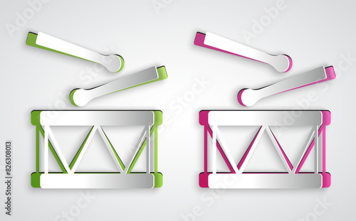 Paper cut Drum with drum sticks icon isolated on grey background. Music sign. Musical instrument symbol. Paper art style. Vector