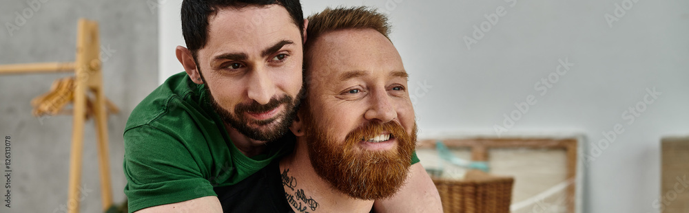 In the center of a room, two men, a gay couple, are hugging tenderly as they move into a new home In the center of a room, two men, a gay couple, are hugging tenderly as they move into a new home