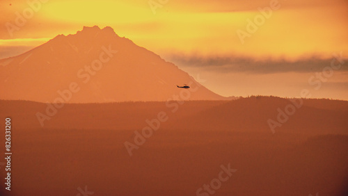 the airplane is flying close to the top of the mountain © Wirestock