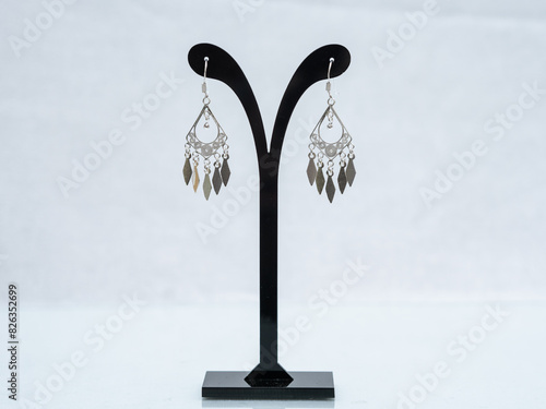 Silver jewelry display on white background photo