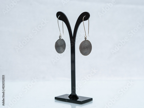 Silver jewelry display on white background photo