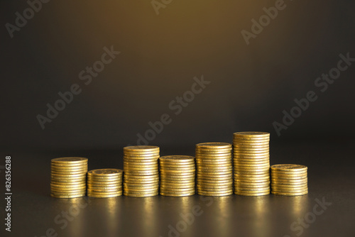 A pile of gold coins on a table suggests wealth and financial success with copy space. Business and financial concept. 
