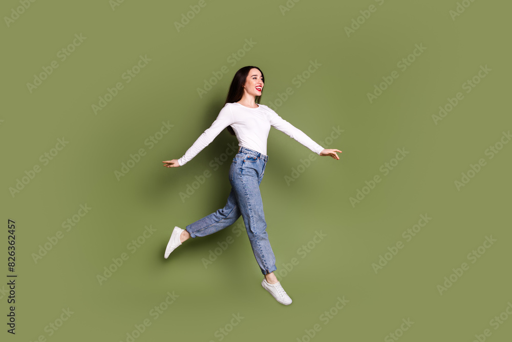 Full body photo of attractive young woman running jump dressed stylish white clothes isolated on khaki color background Full body photo of attractive young woman running jump dressed stylish white clothes isolated on khaki color background