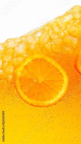 Close up photo of exotic drink with ice cubes and slices of sweet and sour citrus fruit, orange. Textured photo. Abstract wallpaper. Concept of food and drinks, summer,vitamins, nutrition, dieting. Ad photo