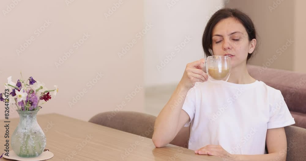 young woman drinking coffee in the kitchen at home. young woman drinking coffee in the kitchen at home.
