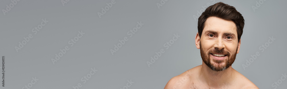 A man without a shirt striking a confident pose. A man without a shirt striking a confident pose.