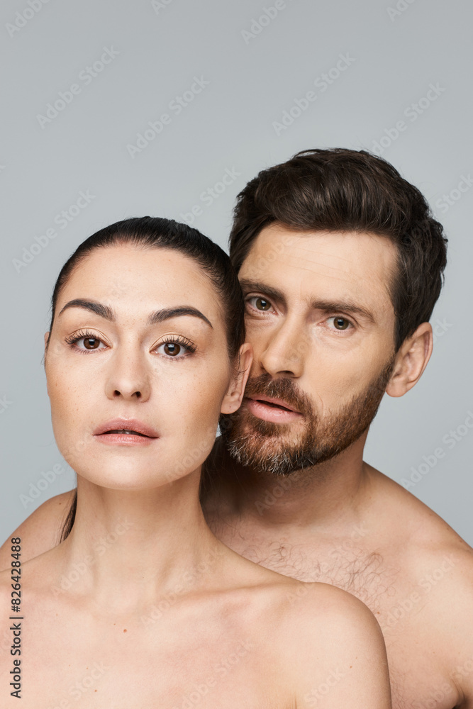 A man and woman elegantly pose together in a photoshoot. A man and woman elegantly pose together in a photoshoot.