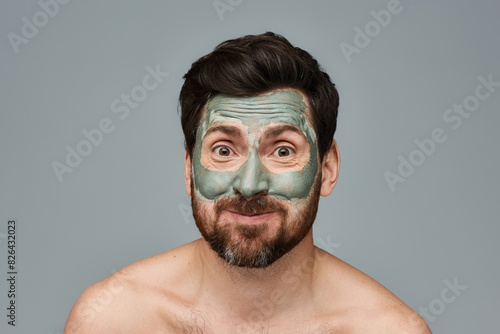 A man wearing a vibrant facial mask.