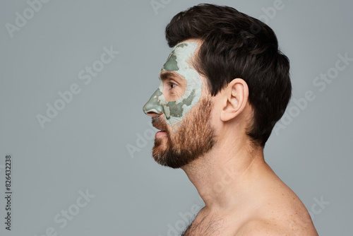 A man wearing a face mask and looking away. photo