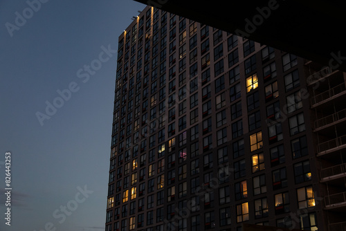 Evening sky backdrop - illuminated windows of a tall apartment building - urban living  modern architecture. Taken in Toronto  Canada.