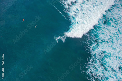 Aerial view of surfers at Geger Surf Point, Uluwatu Peninsula, Bali, Indonesia. photo