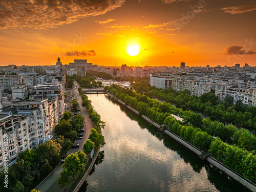 Bucharest from above during sunset. Aerial view over Unirii Square, Boulevard and Palace of the Parliament from Bucharest, summer sunset sky landscape photo. Travel to Romania. photo