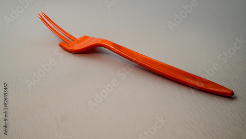 close up view of a broken orange fork isolated on white with empty space background. 