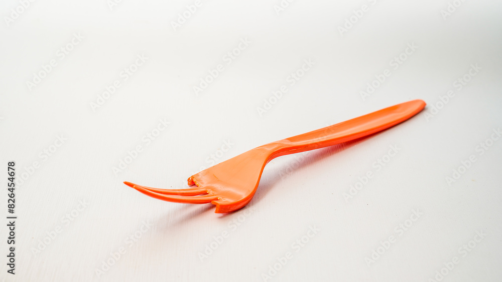 close up view of a broken orange fork isolated on white with empty space background. close up view of a broken orange fork isolated on white with empty space background.
