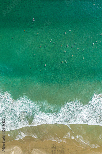 Aerial view of Te Arai Beach with surfers, Wellsford, Auckland, New Zealand. photo