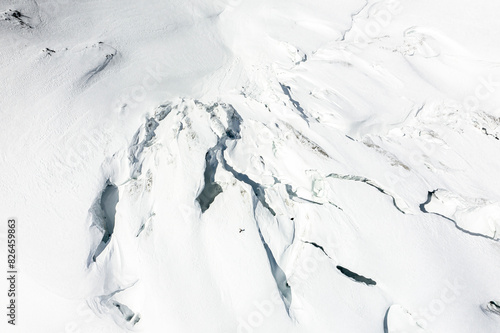 Aerial view of snowy glacier with skiers on Snow Lake, Ski Pulka Expedition, Shigar, Gilgit-Baltistan, Pakistan. photo