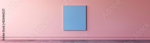 Blue framed artwork hanging on a pink wall, minimalist interior design with a focus on color contrast and simplicity.