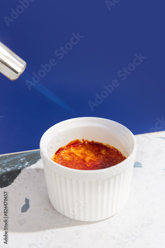 Fotografie Perfectly Caramelized Crème Brûlée in a White Ramekin