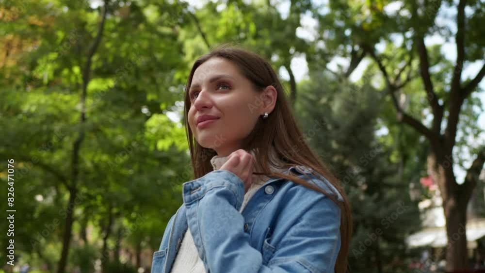 Beautiful woman enjoying walk in park, low angle view. Camera moving around her Beautiful woman enjoying walk in park, low angle view. Camera moving around her
