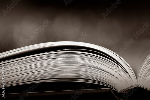 Open book on dark background sepia image