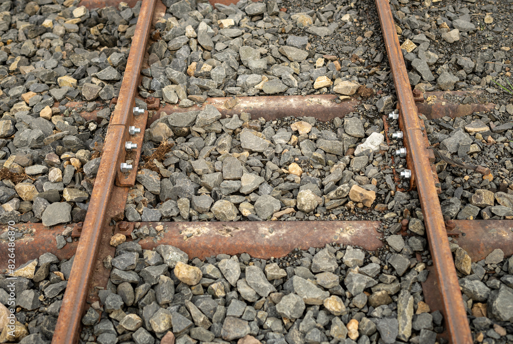 connecting two old and rusty railway sections with new bolts and nuts, rehabilitated for tourism connecting two old and rusty railway sections with new bolts and nuts, rehabilitated for tourism
