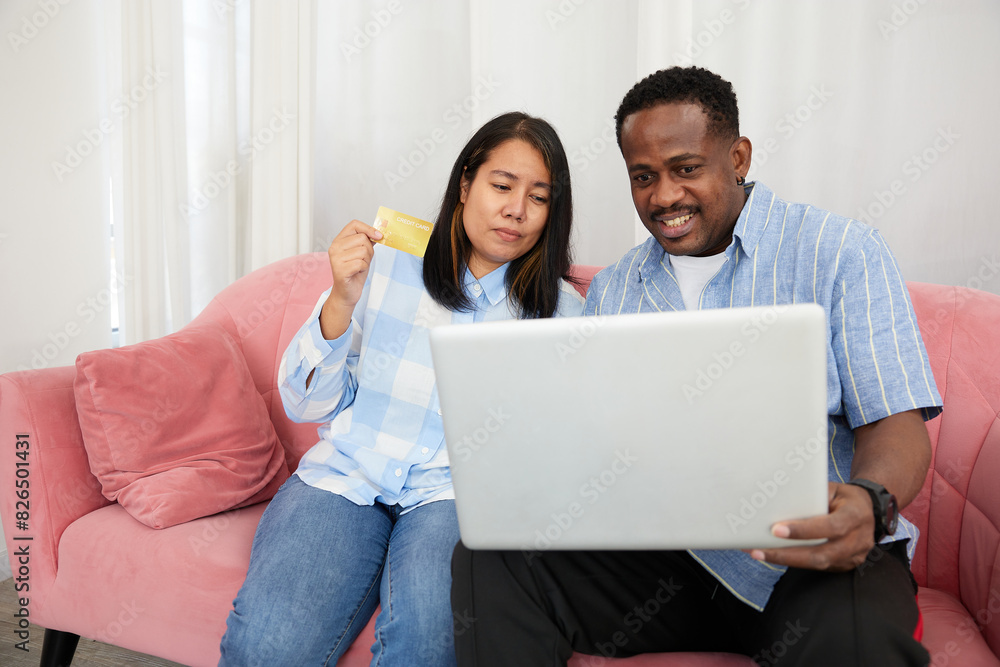 couple using a laptop computer and shopping online with a credit card at home couple using a laptop computer and shopping online with a credit card at home