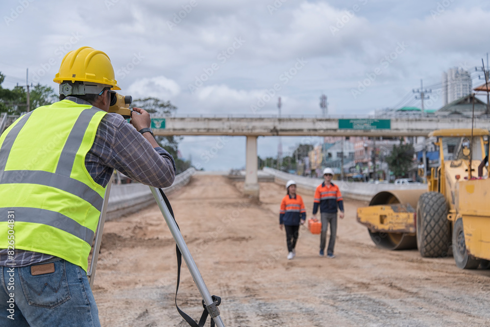 Civil engineer on construction site with survey instrument. woman work with leveling camera on site construction background. Couple worker on site construction. Civil engineer on construction site with survey instrument. woman work with leveling camera on site construction background. Couple worker on site construction.