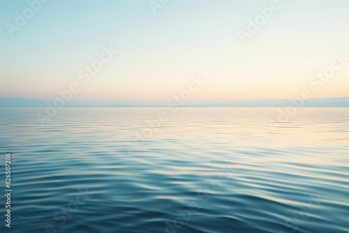 Tranquil Lakeside at Dawn with Gentle Ripples and Clear Sky