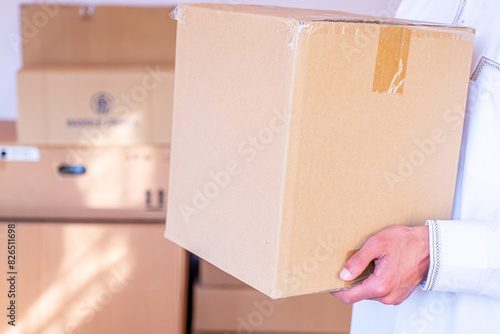 Arabic man holding box of cartoon