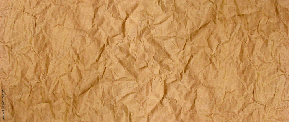 Fototapeta premium Crumpled brown kraft paper background