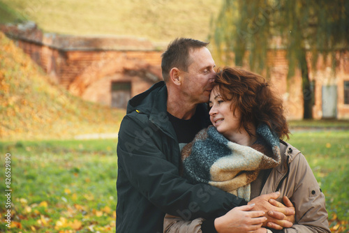 family happy couple hugging in the park in autumn