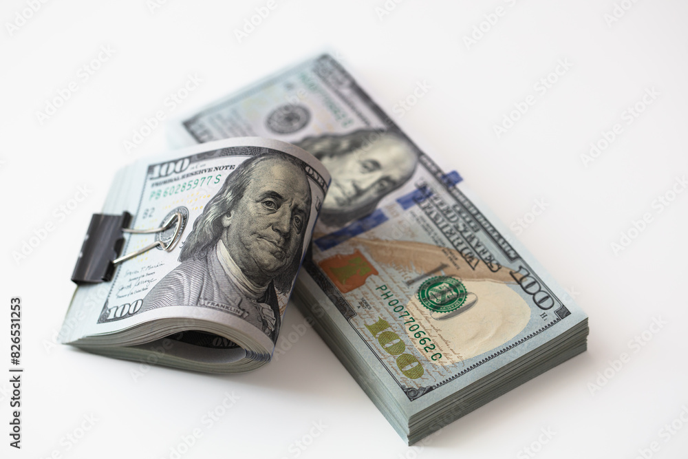 100 dollar banknotes with binder clip on dollars background 100 dollar banknotes with binder clip on dollars background