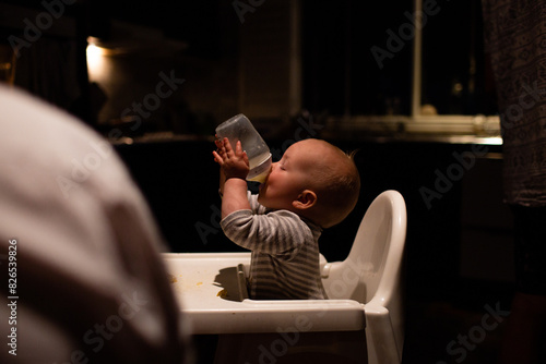 Thirsty baby drinking bottle photo