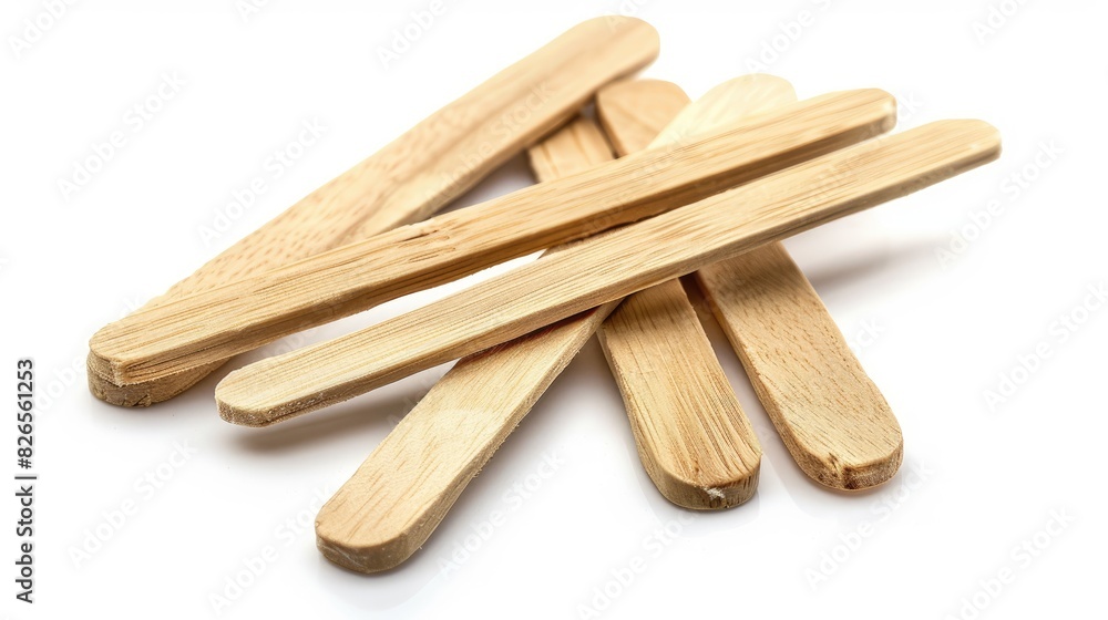 Ice cream sticks made of wood set against a white backdrop Ice cream sticks made of wood set against a white backdrop