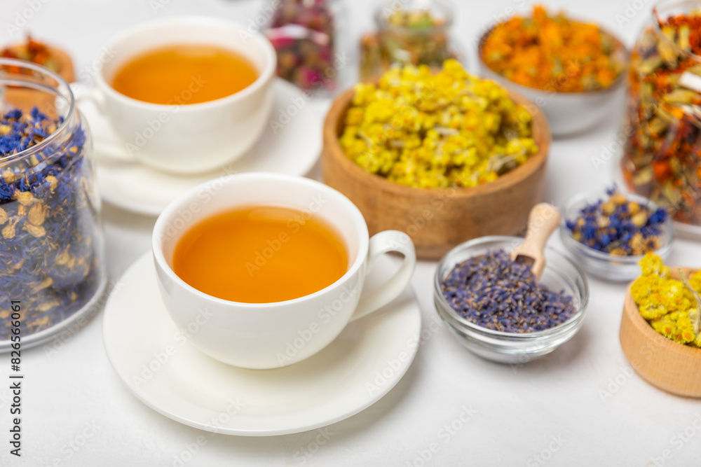 Assortment of dry herbal and berry tea and a cup of tea on a wooden background.Medicinal Healing herbs.Alternative medicine concept.Linden, calendula, cornflowers, marigold, tansy, tea rose.dry herbal Assortment of dry herbal and berry tea and a cup of tea on a wooden background.Medicinal Healing herbs.Alternative medicine concept.Linden, calendula, cornflowers, marigold, tansy, tea rose.dry herbal