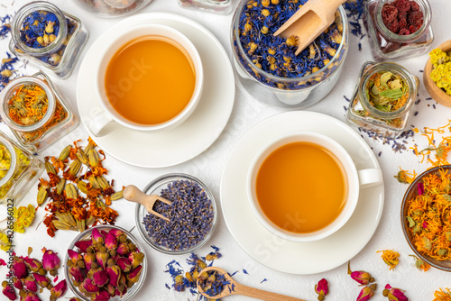 Assortment of dry herbal and berry tea and a cup of tea on a wooden background.Medicinal Healing herbs.Alternative medicine concept.Linden, calendula, cornflowers, marigold, tansy, tea rose.dry herbal