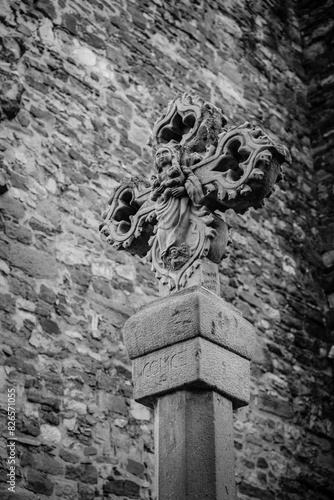 Stone cross on the exterior of the church of Santa Maria de Moia or the Mare de Deu de la Misericordia, parish church in the town of Moia, in Cataliña (Spain) photo